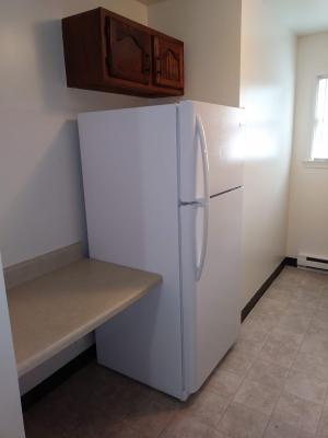 Kitchen that includes a refrigerator